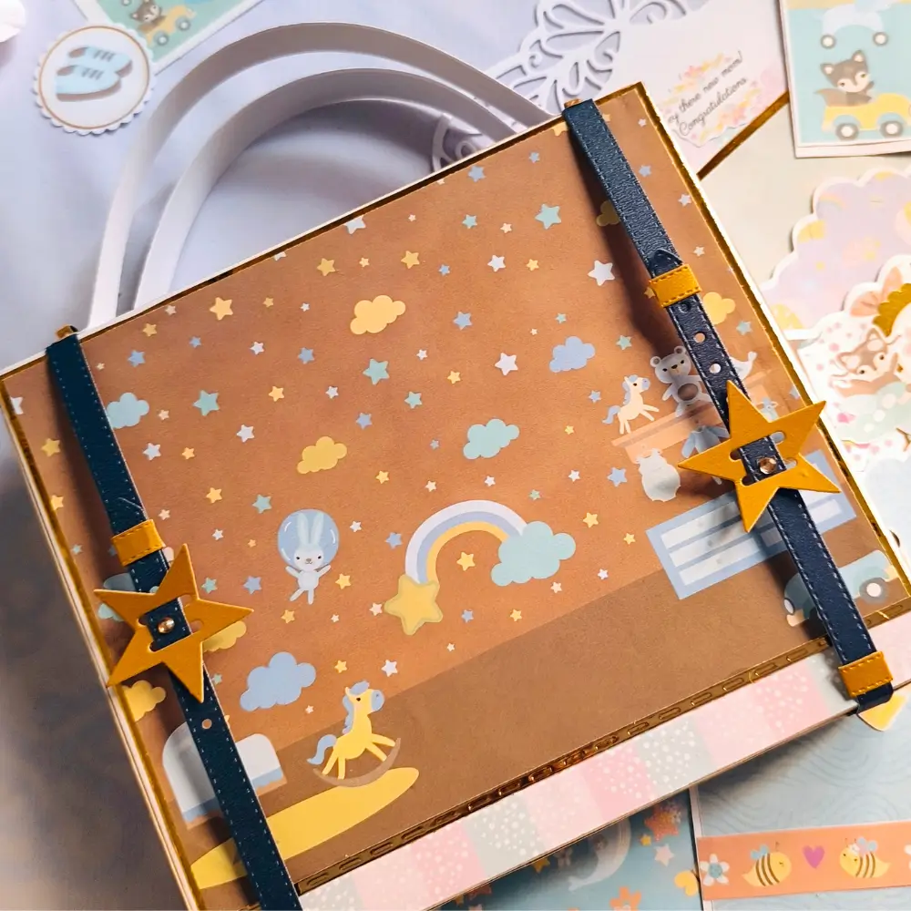 Handmade scrapbook suitcase created with the Life Begins collection by KNC Essentials for storing baby memories, photos, and keepsakes.
